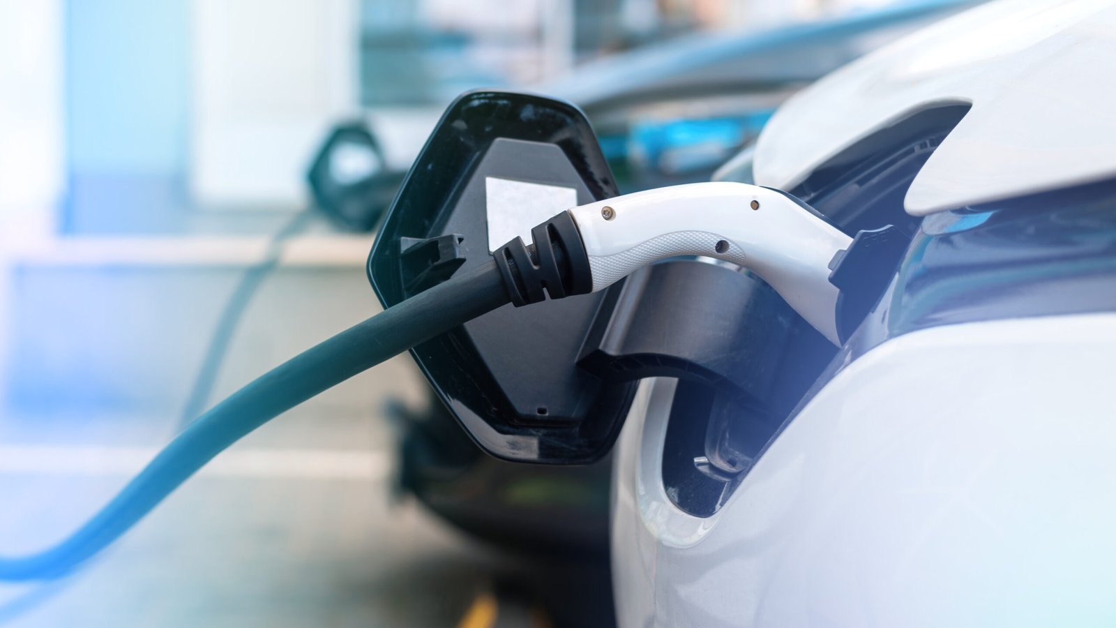 Plugged in charger into a electric car at charge station